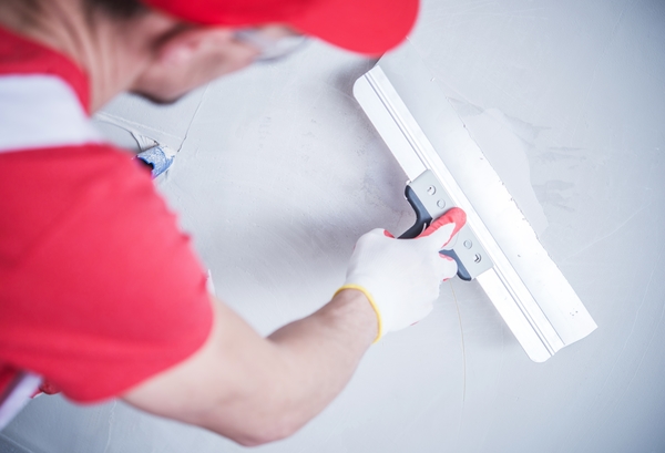 Drywall Patch by Construction Worker